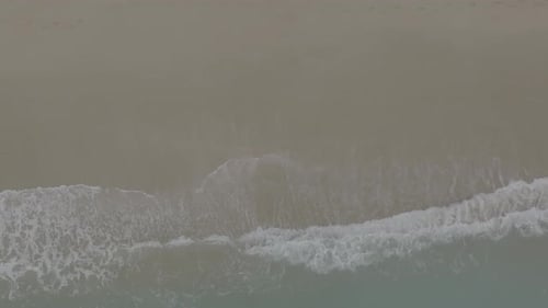 Birds Eye View of Ocean Waves on Beach