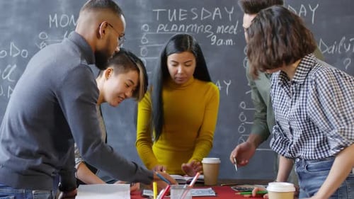 Young Professionals Collaborate on Project in Modern Workplace