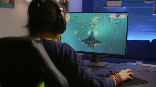 Woman playing space combat game and celebrating victory