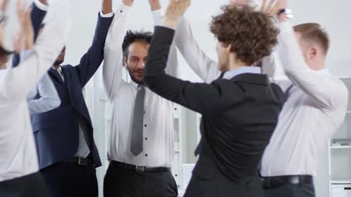 Diverse Office Workers Celebrating Team Success Together