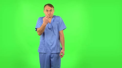 Medical Man Throwing Up Hands Expressing He Is Innocent, Twists His Finger at His Temple. Green