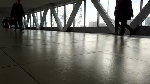 People Walking in Enclosed Pedestrian Walkway