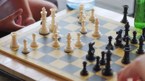 Chess Game in Progress, Child Moves Piece