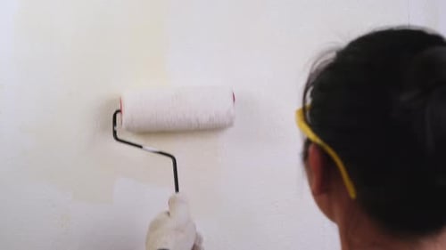 Adult Painting Interior Wall With Paint Roller