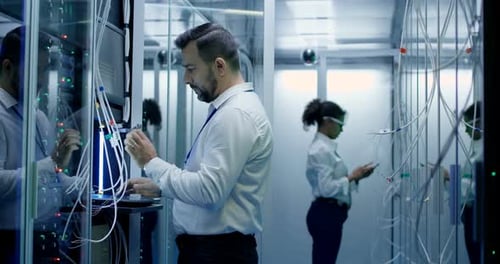 IT Technicians Maintaining Servers in Data Center
