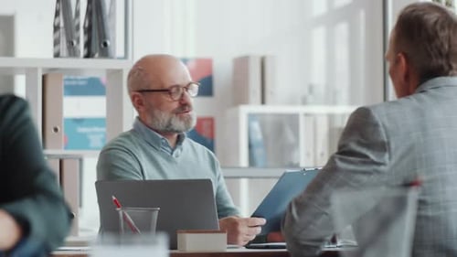 Adults Collaborate at Modern Office Workplace