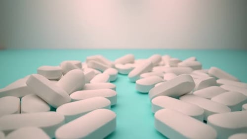 Pile of White Oval Pills Close Up