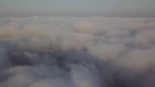 View From a Drone on a Sea of Clouds to the Horizon at Dawn