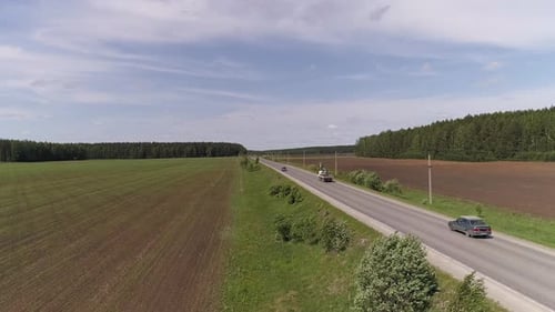 Aerial view of truck crane driving on a straight asphalt road 11