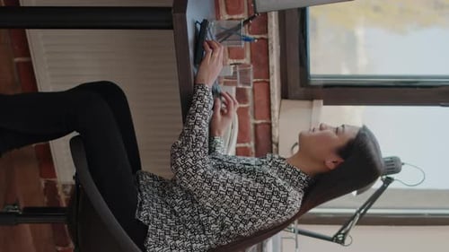 Frustrated Woman Working at Desk in Office