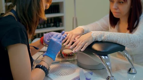 Manicurist Giving a Woman a Professional Manicure