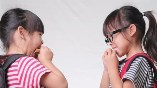 Friendly cheerful classmates sharing healthy meal. Concept of nutrition in school.