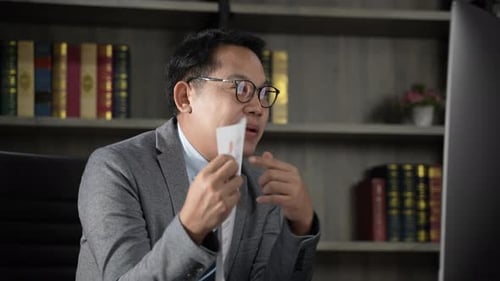 Man in Suit at Desk on Video Conference