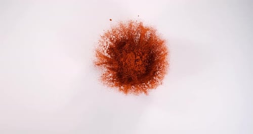Red Dust Cloud Explodes on White Background
