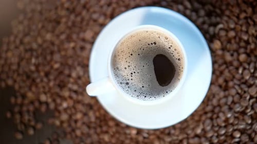 Overhead Shot of Coffee Cup Surrounded by Beans