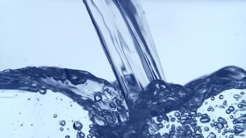 Water Pouring Creating Waves and Bubbles