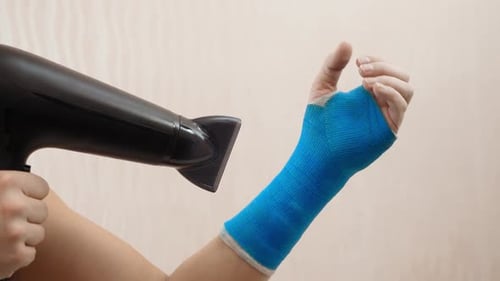 Drying a Blue Arm Cast with Hair Dryer