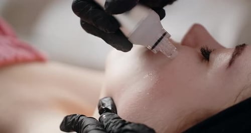 Woman Receiving Facial Treatment in Clinical Setting