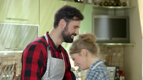 Loving Couple Preparing to Cook Together in Kitchen