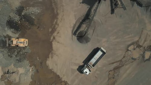 Aerial View of Bulldozer Loading Truck at Quarry
