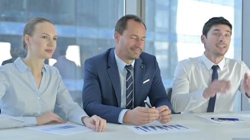 Business Meeting Among Colleagues in Bright Office