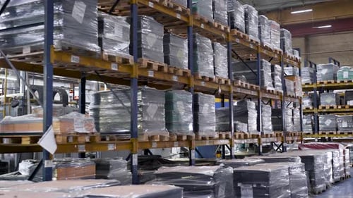Large Warehouse with the Company's Products. Tall Steel Racks with Finished Products Await Shipment