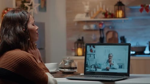 Woman at Home Telehealth Appointment on Laptop