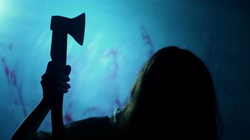 Dark Figure Wielding Axe in Shadowy Scene