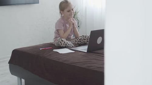 Girl Watches Laptop on Bed at Home