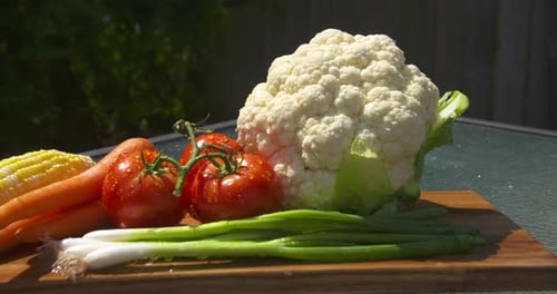 Fresh Produce Display on Sunny Cutting Board