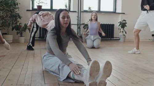 Group of Young Adults Stretching Indoors