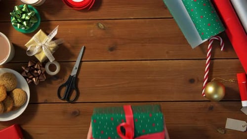 Woman Packing Christmas Gift at Home