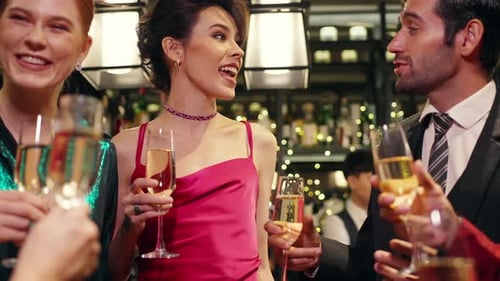 4K Group of people celebrating holiday event with toasting champagne glasses together at luxury bar