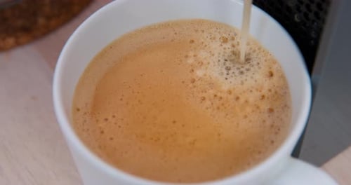 Pouring Coffee into a White Mug Close Up