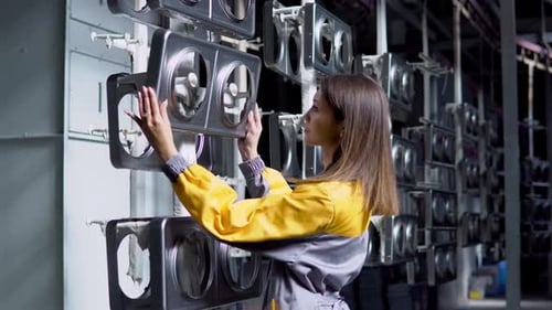 A Young Pretty White Woman Works in the Paint Shop of the Plant She Checks the Unpainted Metall