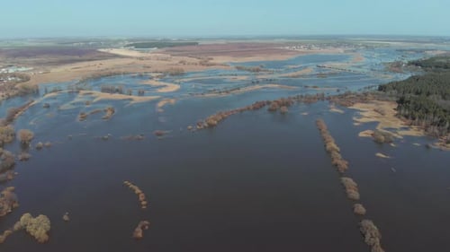 The Camera Flies High Above the Field Where the River Overflowed in the Spring