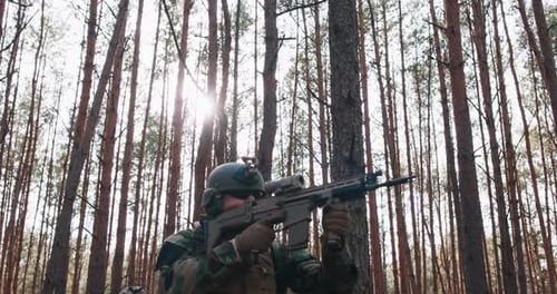 Squad of Fully Equipped Soldiers in Camouflage on a Reconnaissance Military Mission Rifles Ready to