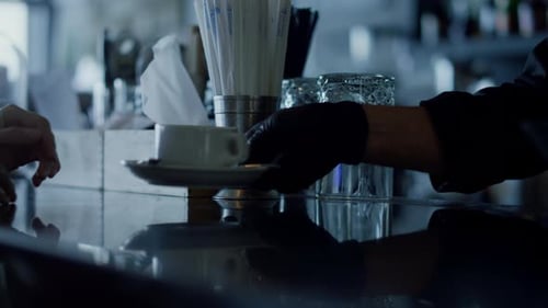 Server Delivers Cappuccino to Customer at Bar