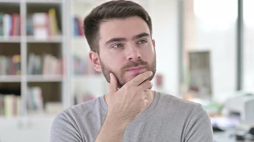 Young Adult Male Thinking with Hand Near Chin