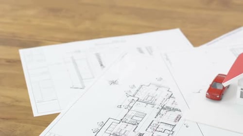 Blueprints and house model on the table