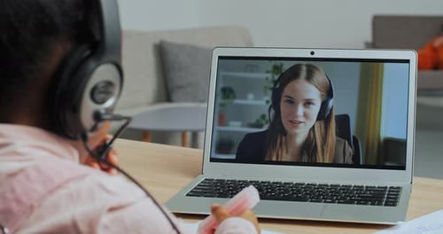 View From Behind Mixed Race Little School Girl Draws Study From Home Remotely During Quarantine