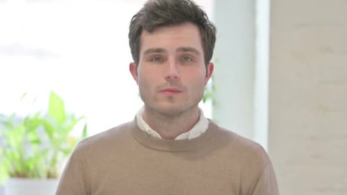 Man Talking Directly to Camera Indoors