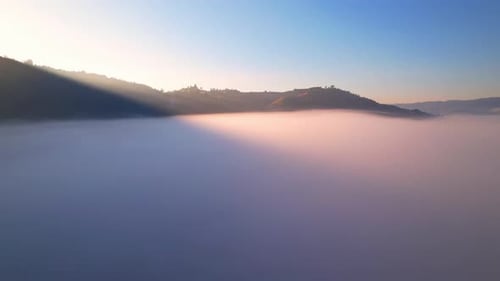 Aerial View of Fog Shrouded Hills at Sunrise