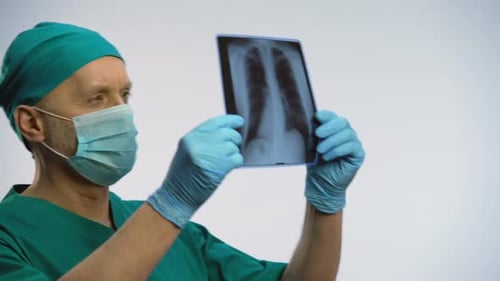 Male Pulmonologist Checking Patients Lungs Scan, Happy With Recovery Results