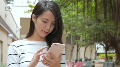 Woman use of mobile phone at park
