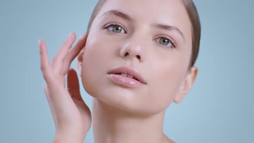 Young Adult Touches Face