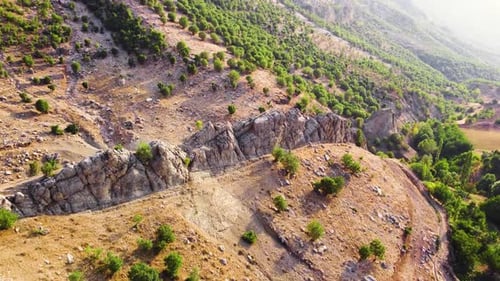 Beautiful Huge Spectacular Cliff Rocks Countryside with Traditional Rural Community in the Golden