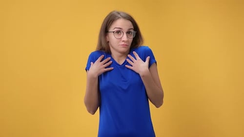 Portrait of Doubtful Woman Don't Know Puzzlement Face Expression Posing Isolated on Orange Studio