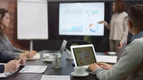 Business Presentation with Charts and Graphs in Workplace