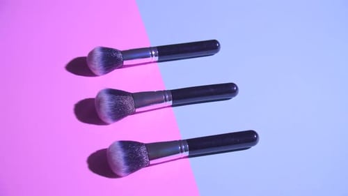 Set of Flat Top View of Professional Female Cosmetics Brush for Makeup on Pink and Blue Background